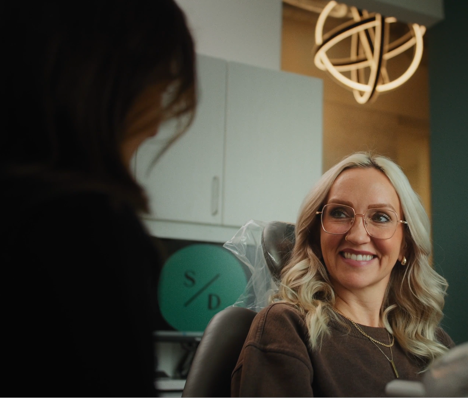 A Sherry Dental team member welcoming a patient at the front desk in Grand Rapids